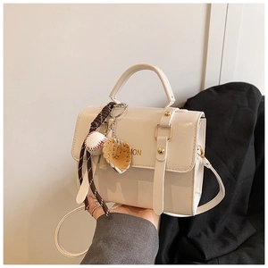 Detail of white PU leather crossbody bag with creative baseball charm and fashion print