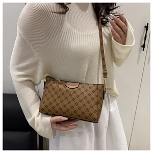 Detail shot of vintage brown monogram shoulder bag with leather FASHION label and stitching