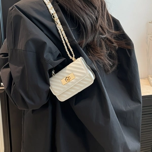 Chic white quilted crossbody bag with gold chain strap and V-pattern stitching for women