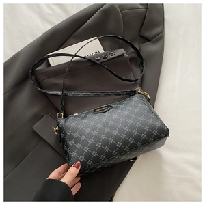 Detail of the blue geometric pattern and Fashion plaque on the PU leather crossbody bag