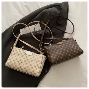 Detail of PU leather crossbody bags with vintage print and adjustable straps