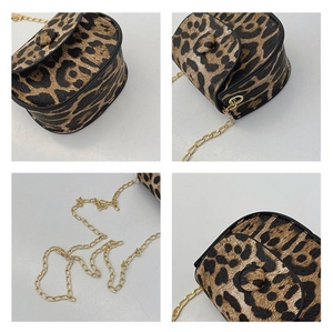 Detail view of mini leopard print chain bag with gold metal strap and saddle design