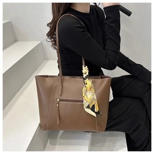 Brown PU leather tote bag detail featuring an elegant printed silk scarf on the handle
