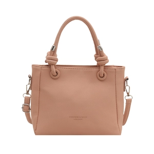 Pink lychee grain leather bucket bag with top handles and adjustable shoulder strap