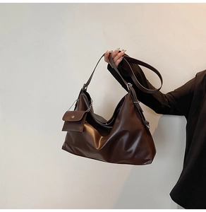 Detail of deep brown large tote bag with textured synthetic leather and mini pouch