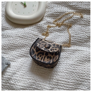 Detail view of mini leopard print saddle bag with chunky gold metal chain strap