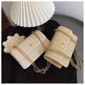 Detailed view of woven straw chain bags with gold metal locks in cream and khaki colors