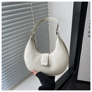 Close-up of cream white hobo bag showing smooth PU leather texture and silver hardware details