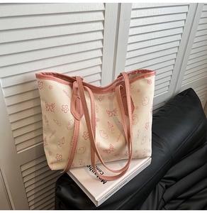 Detail of minimalist cream tote bag with pink trim and cute cartoon illustrations