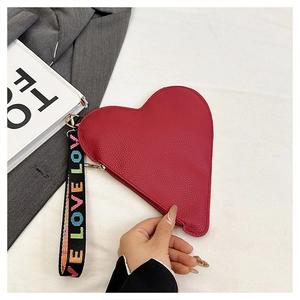 Makroaufnahme der roten herzförmigen Clutch aus PU-Leder mit LOVE-Handschlaufe im Detail