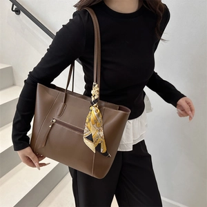 Minimalist brown tote bag with silk scarf and white stitching shown on model