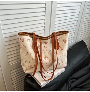 Detail of minimalist tote bag featuring playful prints and deep brown leather trim