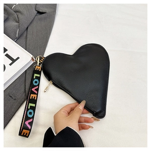 Detail der schwarzen herzförmigen Clutch mit LOVE-Handschlaufe und goldenem Verschluss