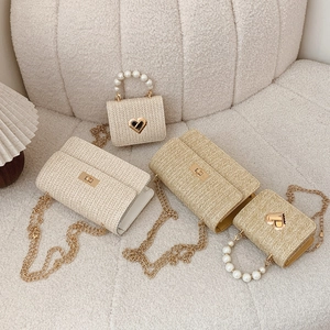 Chic woven straw crossbody bags collection with golden metal locks and pearl handles