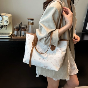 Minimalist white tote bag with brown cartoon prints and straps for work and daily use