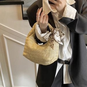 Straw tote bag with silk scarf accessory shown in a stylish mirror selfie