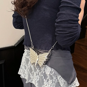 Chic silver butterfly crossbody bag with rhinestones and metal chain on a model