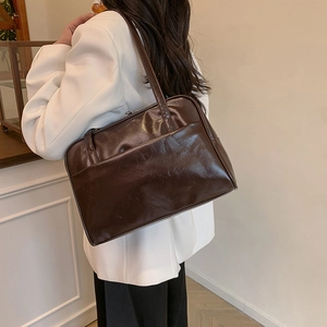Minimalist large dark brown glossy leather tote bag shown from a back perspective