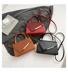 Three fashion crocodile pattern leather handbags in red brown and black with gold bars
