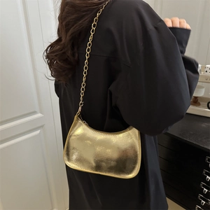 Chic golden crescent underarm bag with metallic finish and chain strap for women