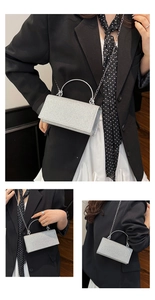 Detail of silver rhinestone evening clutch with ring handle and metal chain strap