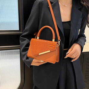 Chic orange crossbody bag with crocodile texture flap and gold hardware for women