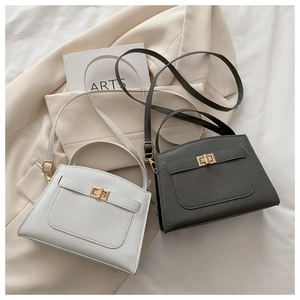 Litchi texture crossbody bags in white and dark grey with elegant metal twist locks