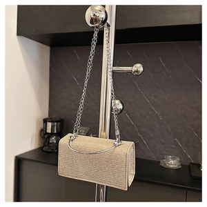 Champagne gold glitter evening bag featuring a metallic top handle and elegant chain strap