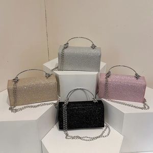 Sparkly evening handbags in silver, gold, pink, and black with metallic knot handles