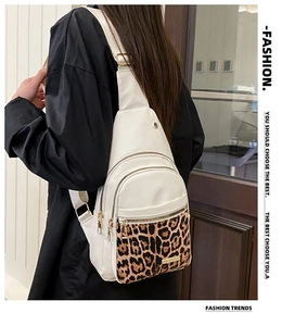 Rear view of model wearing white PU leather chest bag with stylish leopard print accent