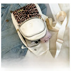 Detail view of the spacious white crossbody bag interior with leopard print panel