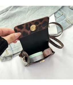Detail of leopard print flap bag with gold magnetic clasp and internal storage capacity