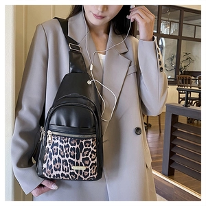 Close-up of stylish leopard print stitching and smooth matte PU leather on a crossbody bag