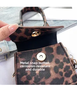 Detailed view of the durable magnetic snap closure on leopard print mini handbag