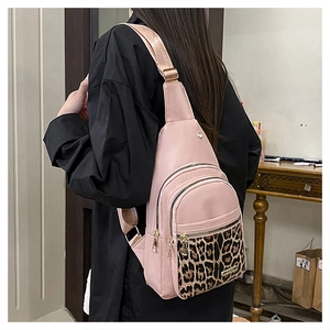 Detailed side view of pink leopard print sling bag with multi-zipper compartments