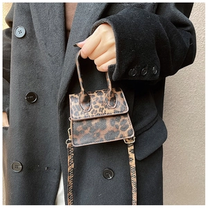 Detail of leopard print mini crossbody bag with textured faux leather and slim shoulder strap