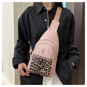 Detail view of pink leopard print crossbody bag with adjustable wide brown strap