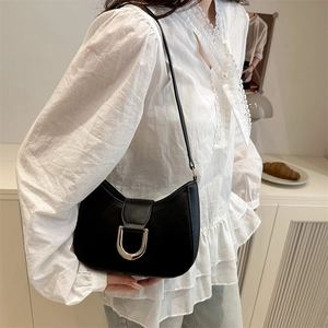 Minimalist black crescent shoulder bag with gold metal buckle for daily commute