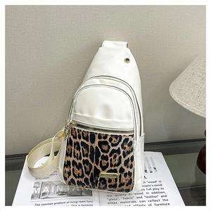 Chic leopard print crossbody chest bag placed on vintage magazines for style display