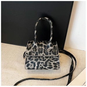 Detail of mini leopard print handbag with golden hardware and adjustable strap