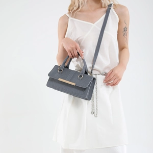 Minimalist grey textured shoulder bag with a stylish gold metal bar handle detail