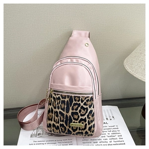 Detail of pink leopard print crossbody chest bag with zipper layers and metal logo
