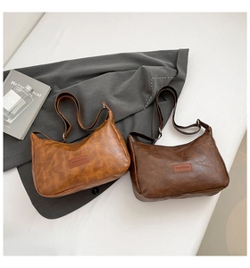 Flat lay showing vintage brown oil wax leather shoulder bags with fashion patches