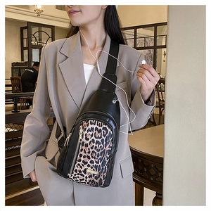 Detail of leopard print crossbody chest bag with adjustable strap and golden logo