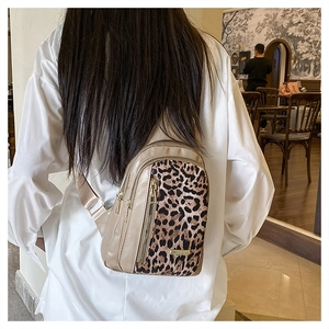 Detail of leopard print crossbody bag with triple gold zippers and adjustable strap