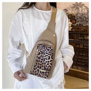 Fashionable leopard print crossbody bag with multiple zip pockets and wide strap details