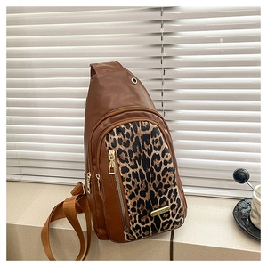 Detail of leopard print stitching and golden hardware on fashionable brown crossbody bag