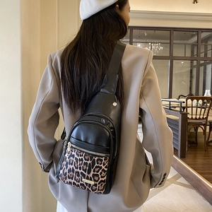 Chic black PU leather chest bag with leopard print pocket and multiple zippers