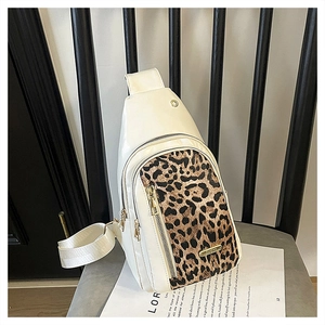 Detail of white leather chest bag with leopard print panel and gold earphone port
