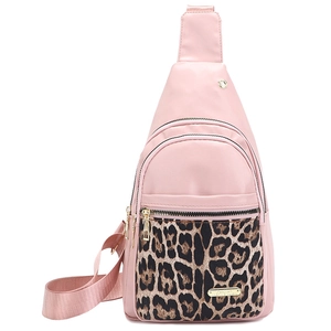 Pink waterproof nylon crossbody bag with leopard print accent and gold hardware